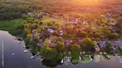 Aerial views of lake front and lakefront homes during a summer sunset.