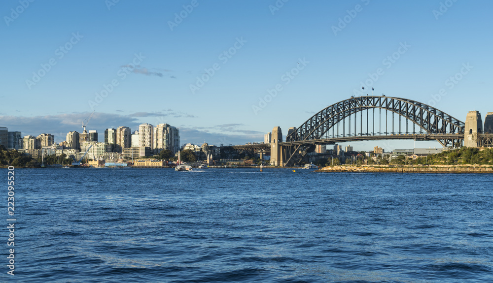 Sydney Harbour with Bridge and North Sydney viewed from Balmain on a sunny afternoon