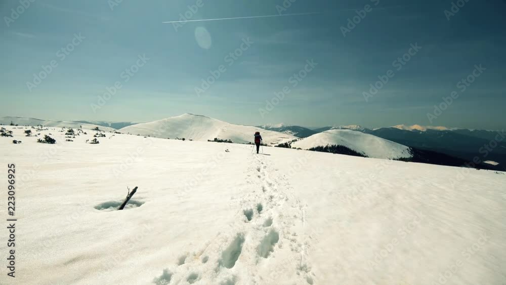 a group of tourists travels through the snow-capped mountains
