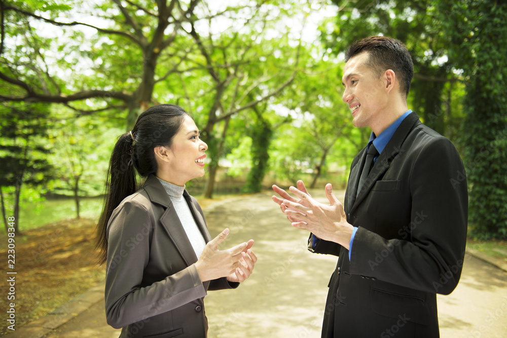 Attractive asian business people having serious conversation Attractive asian business people having serious conversation