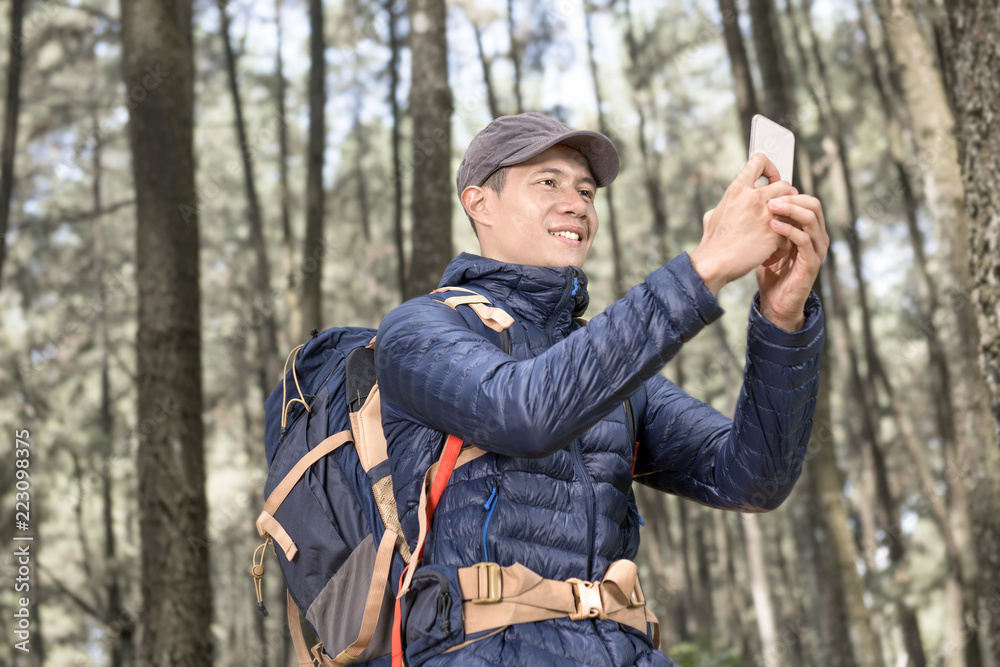 Attractive asian traveler man making photo with mobile phone Attractive asian traveler man making photo with mobile phone