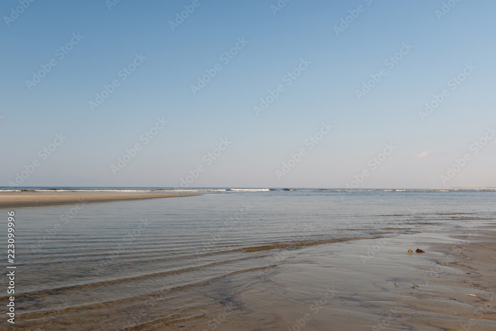 Tidal pool and waves on the Atlantic Ocean shore, Sunset Beach, North Carolina