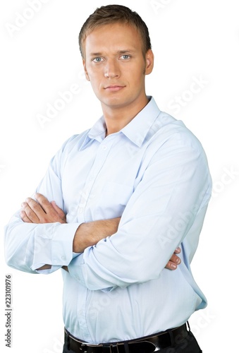 Professional looking man with his arms crossed wearing a button