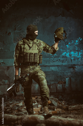 the people in uniform with weapons in the ruins © rotozey