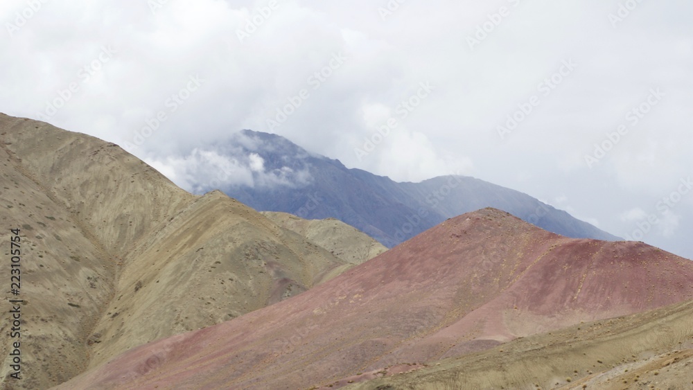 Rolling clouds over colorful mountains along the Sham Valley Trek in the Himalaya Rolling clouds over colorful mountains along the Sham Valley Trek in the Himalaya