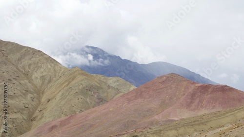 Rolling clouds over colorful mountains along the Sham Valley Trek in the Himalaya 