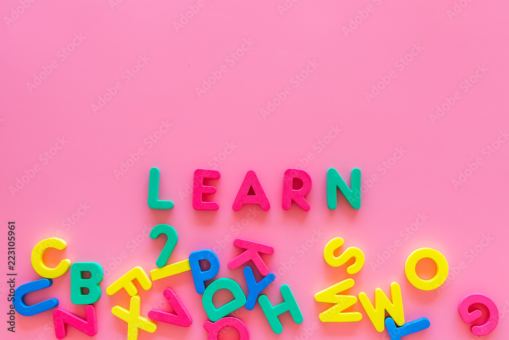 Children learn read concept. Word learn written by plastic letters on pink background top view space for text Children learn read concept. Word learn written by plastic letters on pink background top view space for text