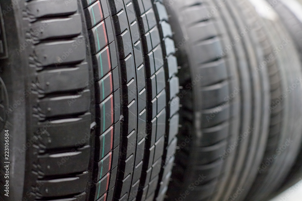 Protector of automobile tires. A number of automobile tires. Close up view on auto mobile new wheel tire surface. Different pattern and type tires for car industry commercial transport transpotration.