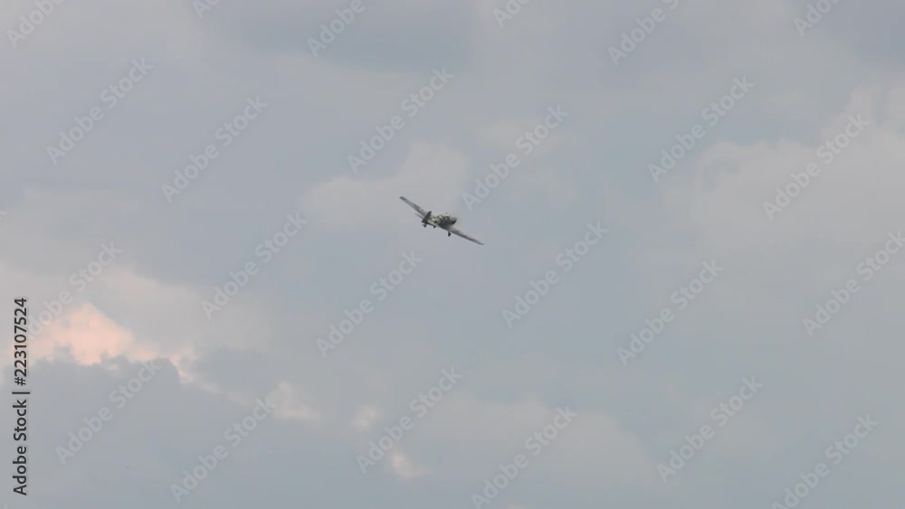 A historical plane performs barrels and pirouettes. Plane fly in the sky. A cloudy sky. A historical plane performs barrels and pirouettes. Plane fly in the sky. A cloudy sky.