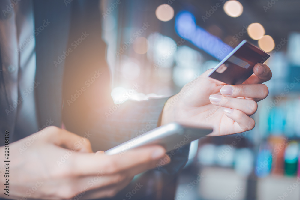 Business woman hand use credit cards and smartphones.