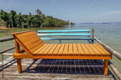 Orange wooden deckchair in mangroves sea in South East Asia, sdraio arancione in legno nelle mangrovie nel sud est asiatico in prosimita' del mare photo