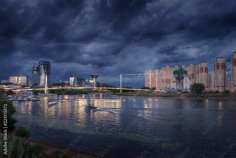 Moscow region. July 02, 2018. Thunderous sky over the Moscow River  The embankment.  Pavshinsky Bridge. Crocus City Exhibition Complex and the Government House