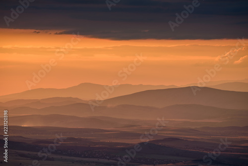 Amazing sunset in the mountains - beautiful golden light peaking through storm clouds with vivid colors and picturesque scenery - perfect relaxation spot © photoenthusiast