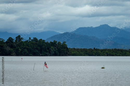 National flag of Malaysia or "Jalur Gemilang" at lake Bukit Merah in Malaysia.