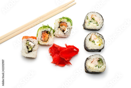 Food abstract background. On the white plane lie rolls or sushi, ginger plates and sticks for sushi.