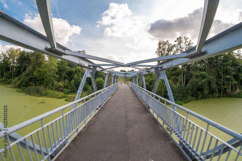 iron steel frame construction of pedestrian bridge across the river