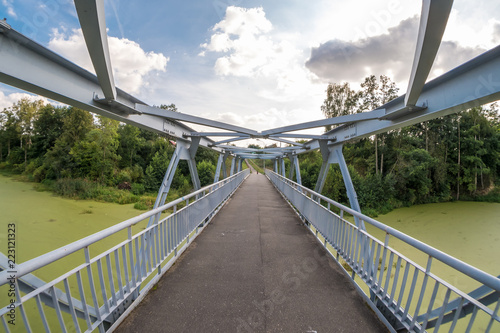 iron steel frame construction of pedestrian bridge across the river