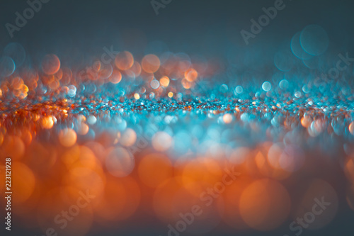 Abstraction orange bokeh on a blue background. Defocused. photo