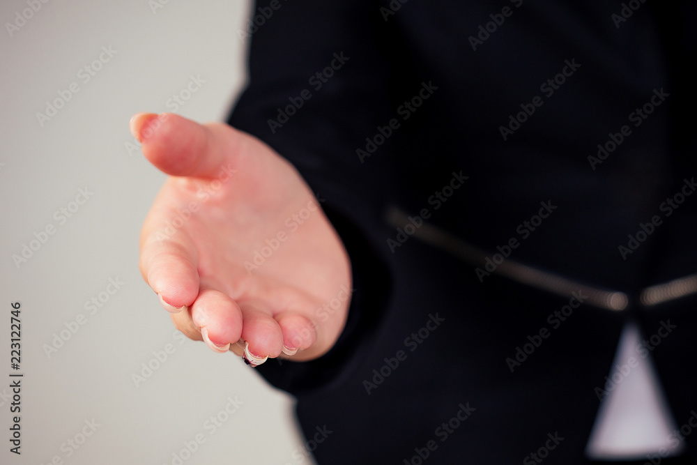 Fototapeta premium beautiful woman in a business black suit in the studio on a white background