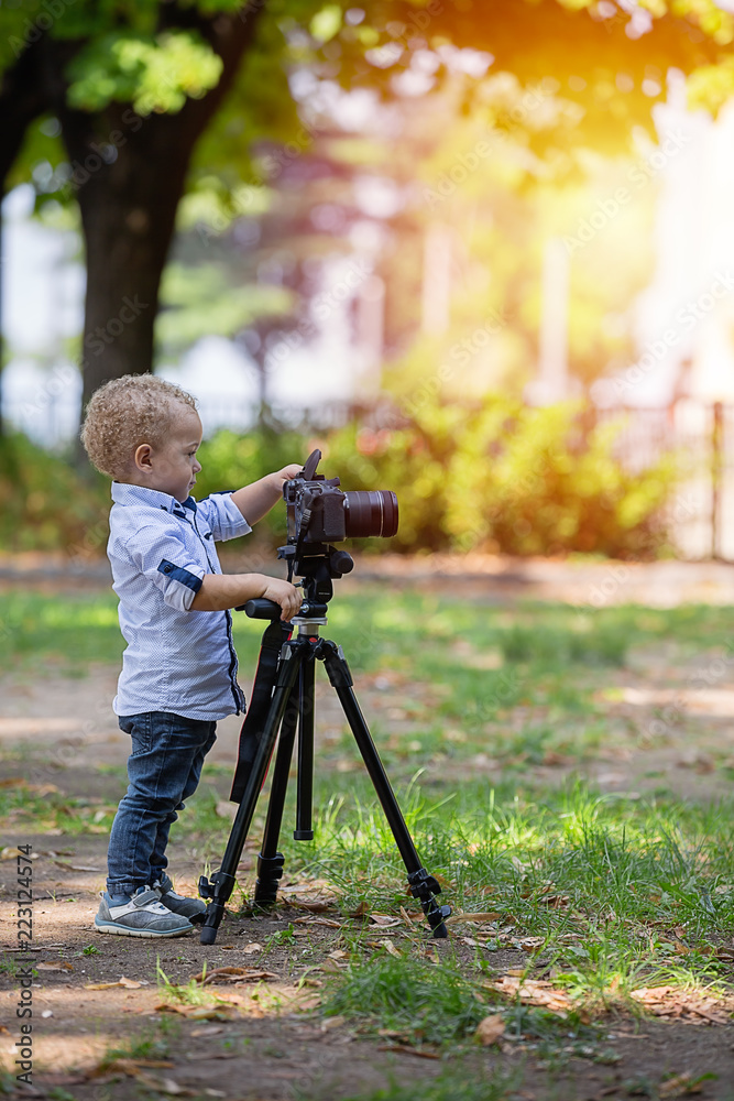  A two years old boy is photographer.