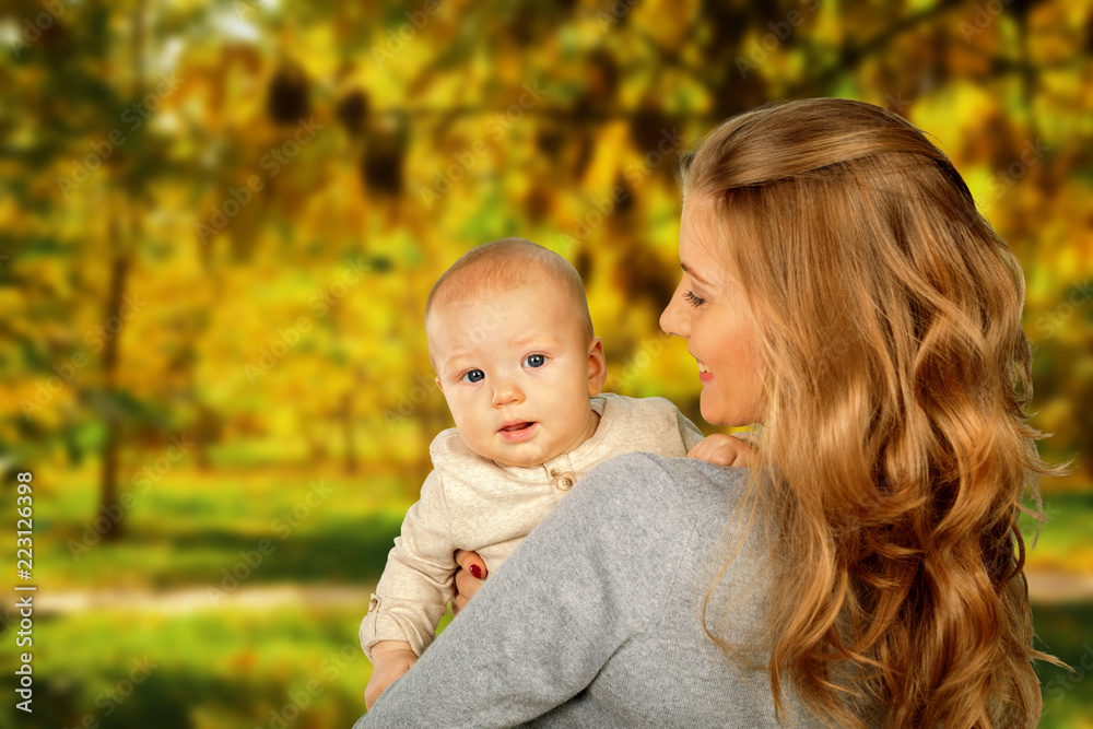 Mother hugging her child during walk in the park Mother hugging her child during walk in the park