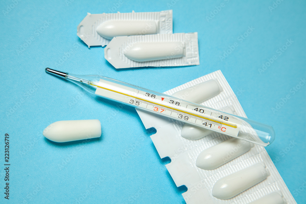 Suppository for anal or vaginal use and thermometer. Candles for treatment  of high temperature Stock-Foto | Adobe Stock