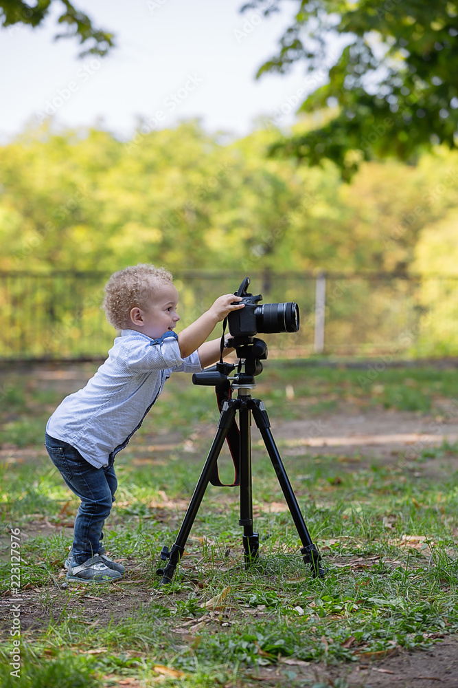  A two years old boy is photographer.