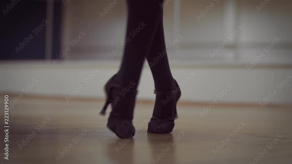 Dancing female legs in the dance studio Dancing female legs in the dance studio