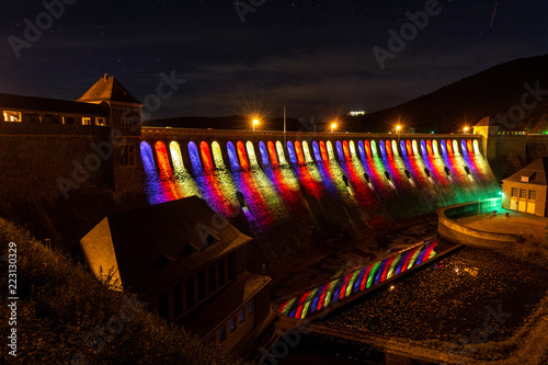 Colourfully lit reservoir dam at the lake Edersee photo