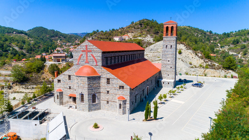 Aerial view of Agios Arsenios church, Kyperounda village, Limassol, Cyprus. Traditional landmark christian greek orthodox, ceramic tiled roof, stone bell tower architecture in Kyperounta from above photo