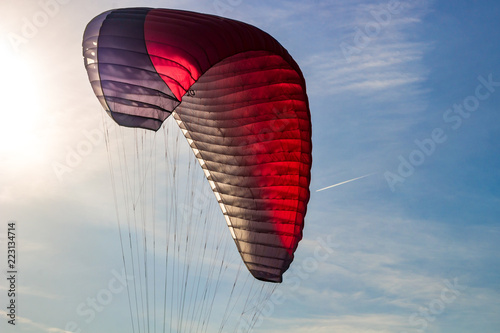 The wing of a paraglider in flight in the air 