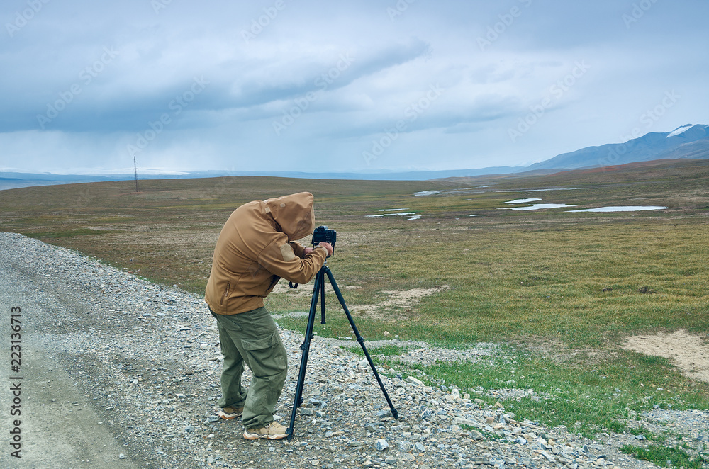 Photographer taking photo on highest mountain