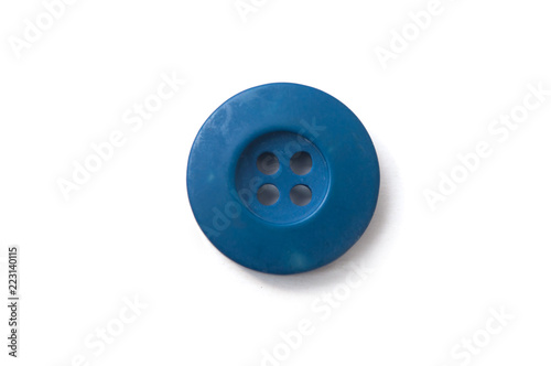 closeup of blue sewing button on white background