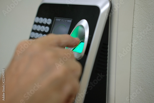 hand scanning finger print on access control machine. hour work time recording & security