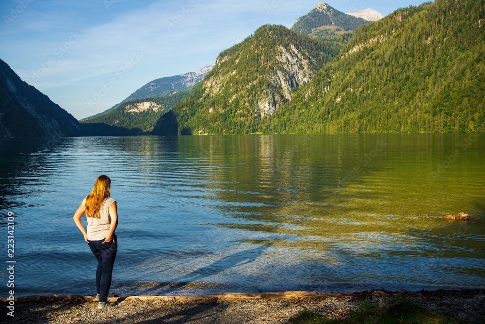 Woman enjoying the late summer view at a lake late in the afternoon Woman enjoying the late summer view at a lake late in the afternoon