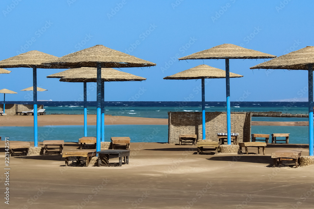 Sea beach with umbrellas and sun loungers