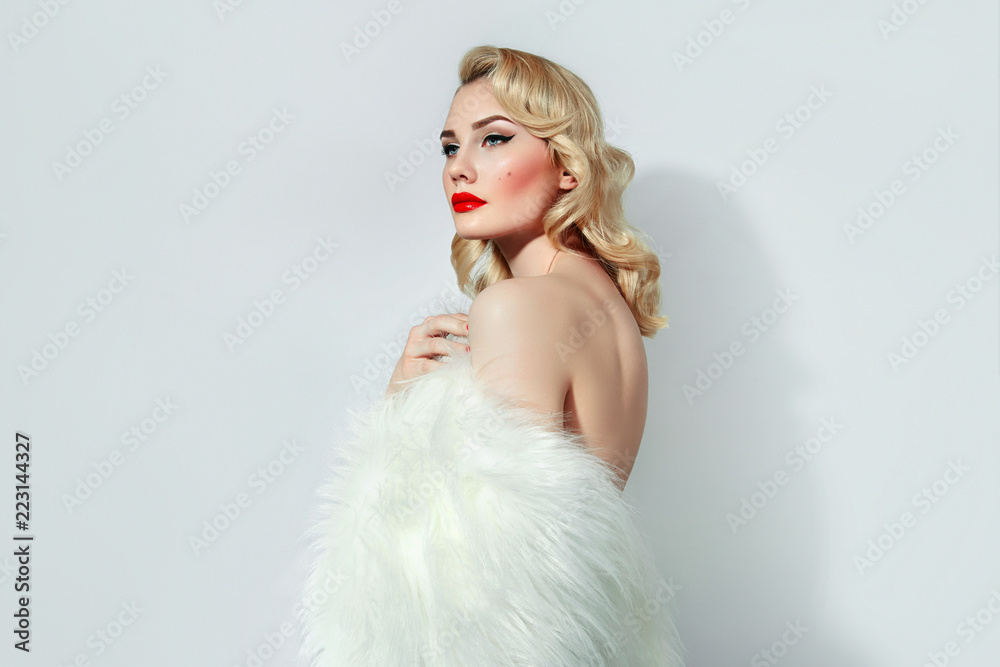 Portrait of a beautiful young girl with blond wavy hair and with red lips and black arrows in retro style. Portrait of a beautiful young girl with blond wavy hair and with red lips and black arrows in retro style.