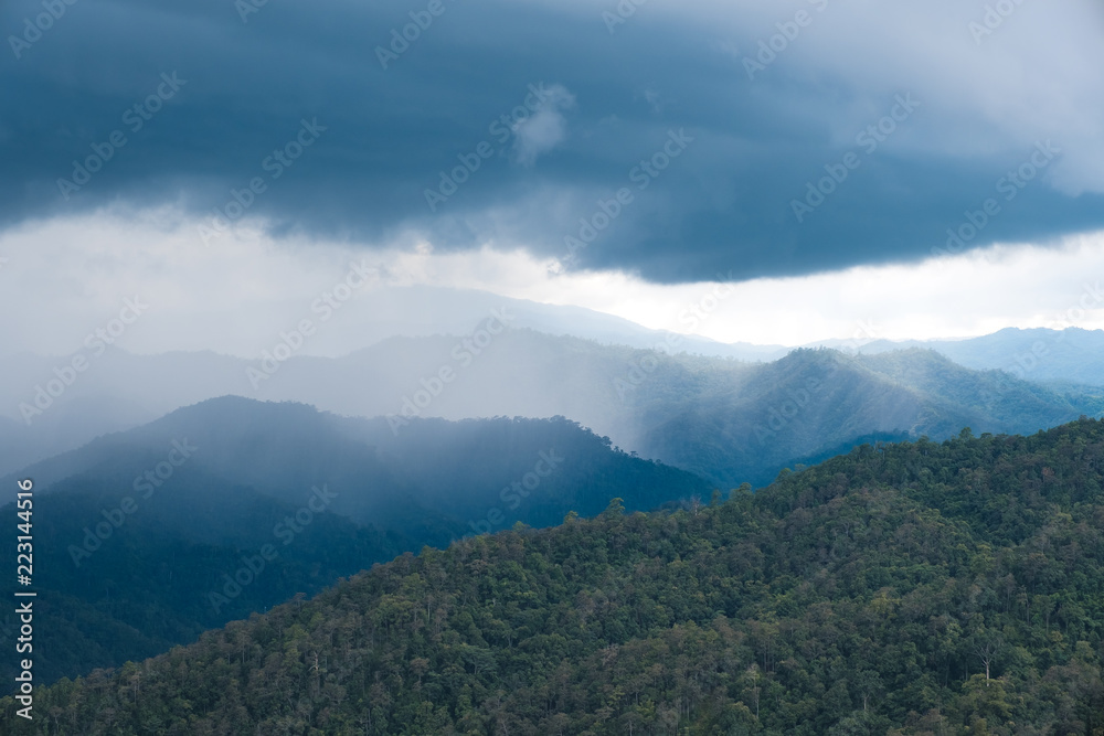 Landscape image of greenery rainforest hills on rainy day with cloudy sky background