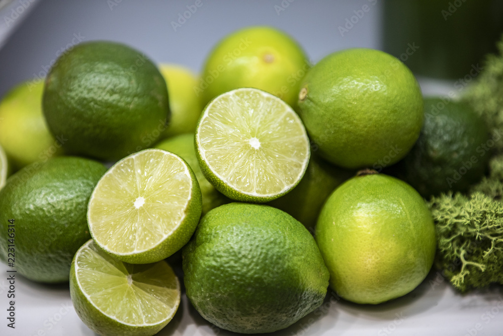 Full and cut lemons in a basket alongside with broccoli Full and cut lemons in a basket alongside with broccoli