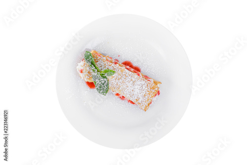 Dessert with cream, whipped cream, berry, strawberry syrup and biscuits, puff pastry, mint leaf, powdered sugar, on a plate, isolated white, view from above. For the menu of a cafe, restaurant, bar