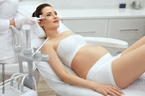 Face Skin Cryo Therapy. Pregnant Woman At Cosmetology Treatment photo