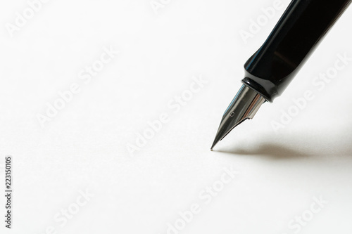 Fountain pen placed on the white paper opaque. Communication to business transactions, education, work, suitable as a background image.