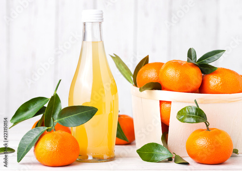 Glass bottle of fresh mandarin tangerine juice