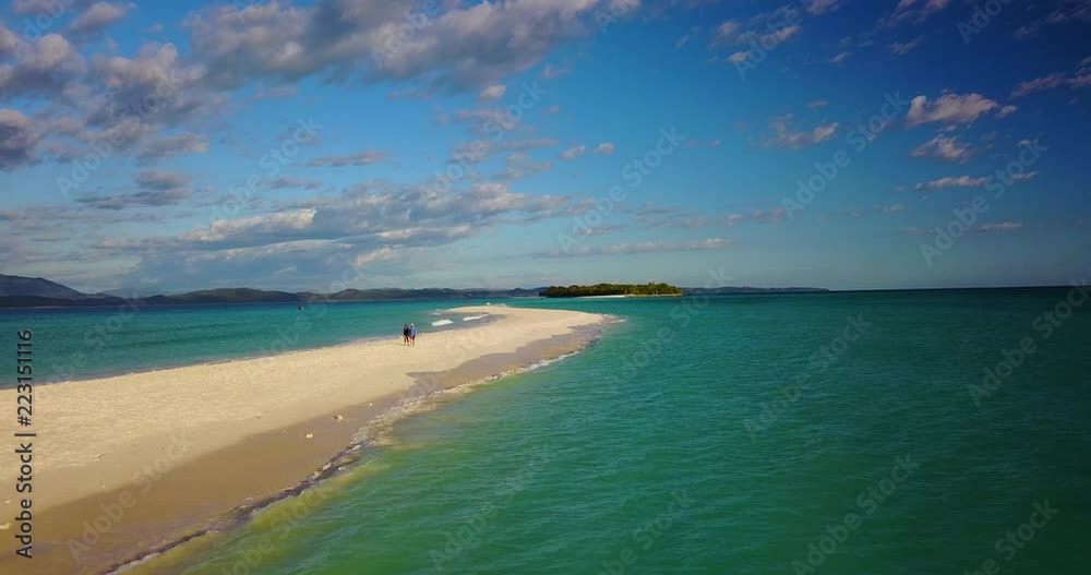 Aerial view of a magnificent landscape: an island with white beach, crystal clear sea, palm trees. Wonderful places for a dream vacation. Concept of: holiday, wild, nature.