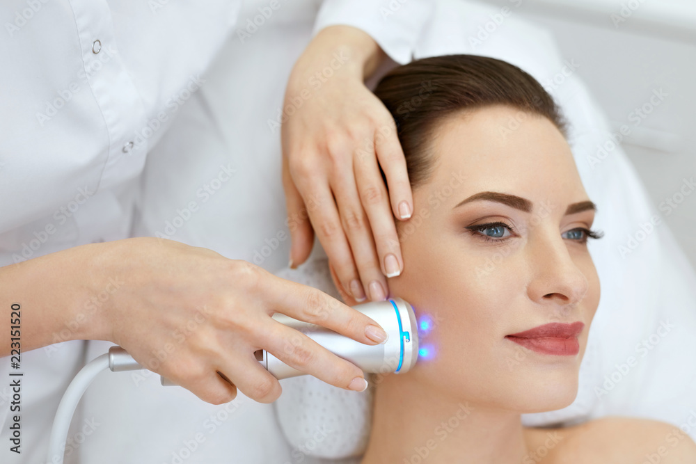 Beauty. Woman Doing Blue Light Facial Treatment On Face Skin