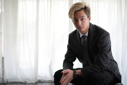 Young Asian businessman in white shirt and tie