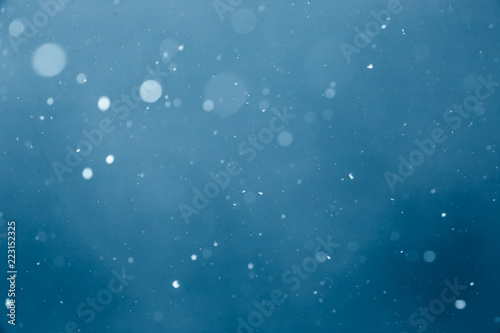 Falling Snow On The Blue Background