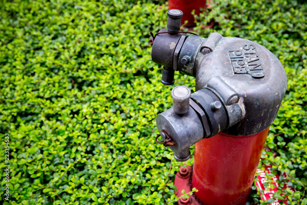 Red fire pump in front of concrete wall. fire safety pump on cement floor of concrete building. Deluge system of firefighting system. Plumbing fire protection. High pressure fire safety pump. Red fire pump in front of concrete wall. fire safety pump on cement floor of concrete building. Deluge system of firefighting system. Plumbing fire protection. High pressure fire safety pump.