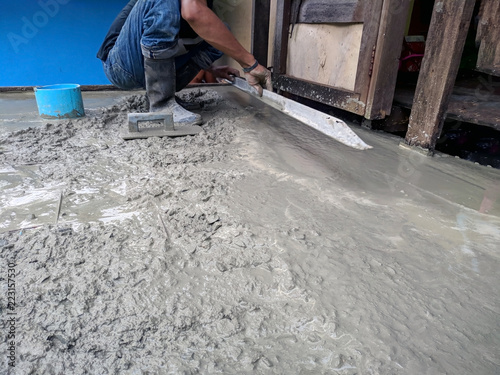 Construction worker in liquid concrete.