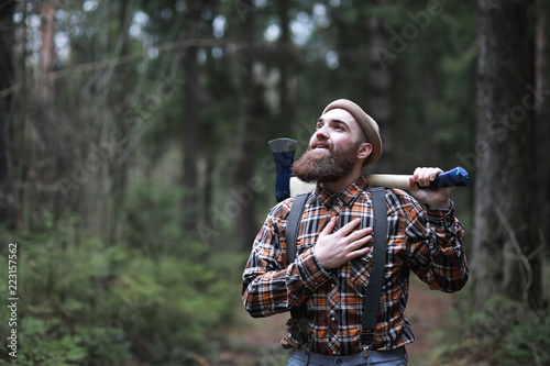 A bearded lumberjack with a large ax  photo